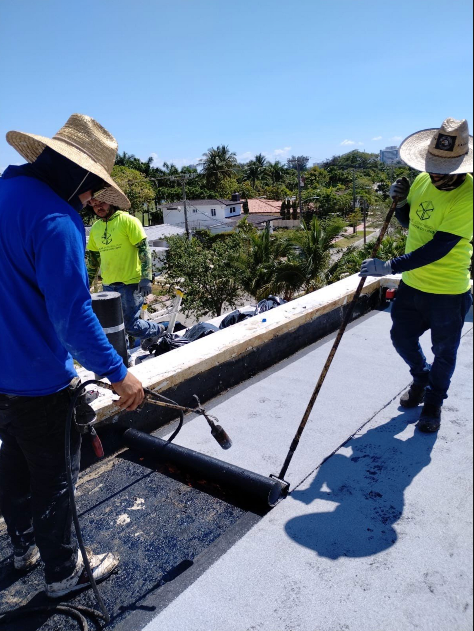 A group of men are working on a roof.