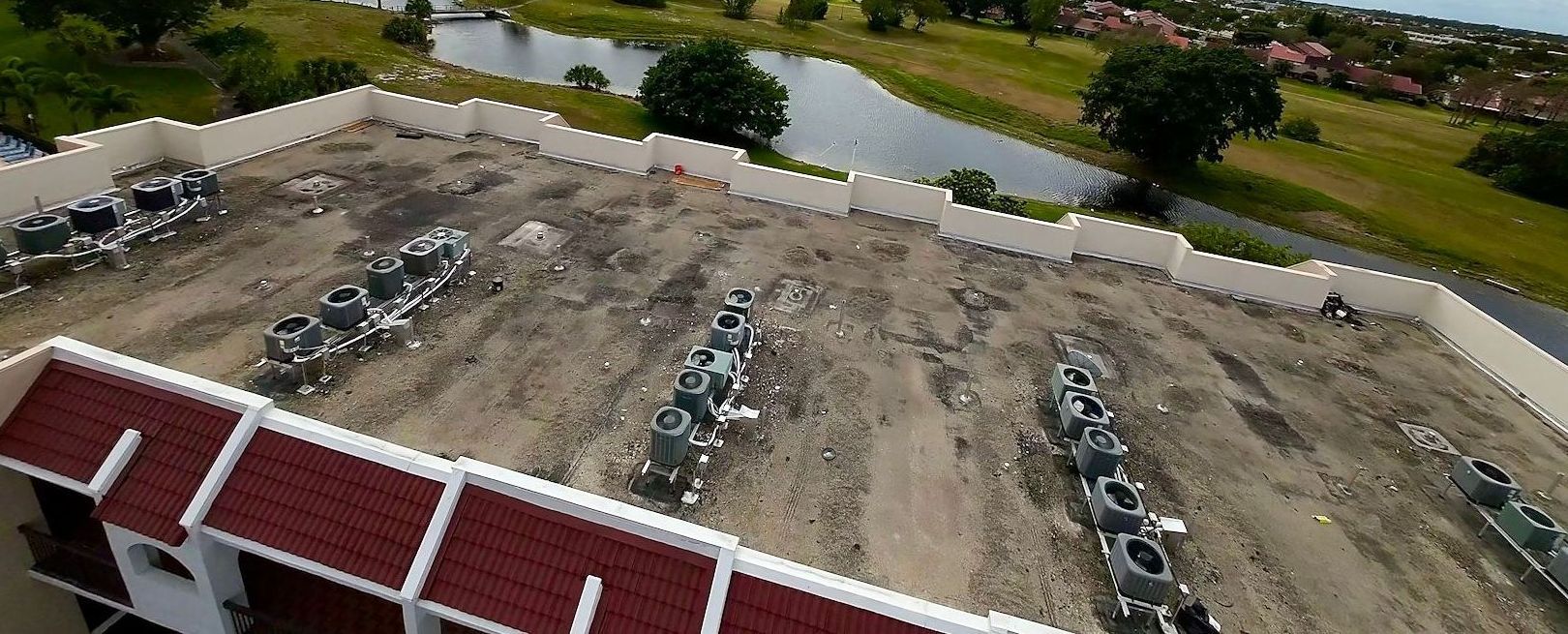 An aerial view of a building with a red roof