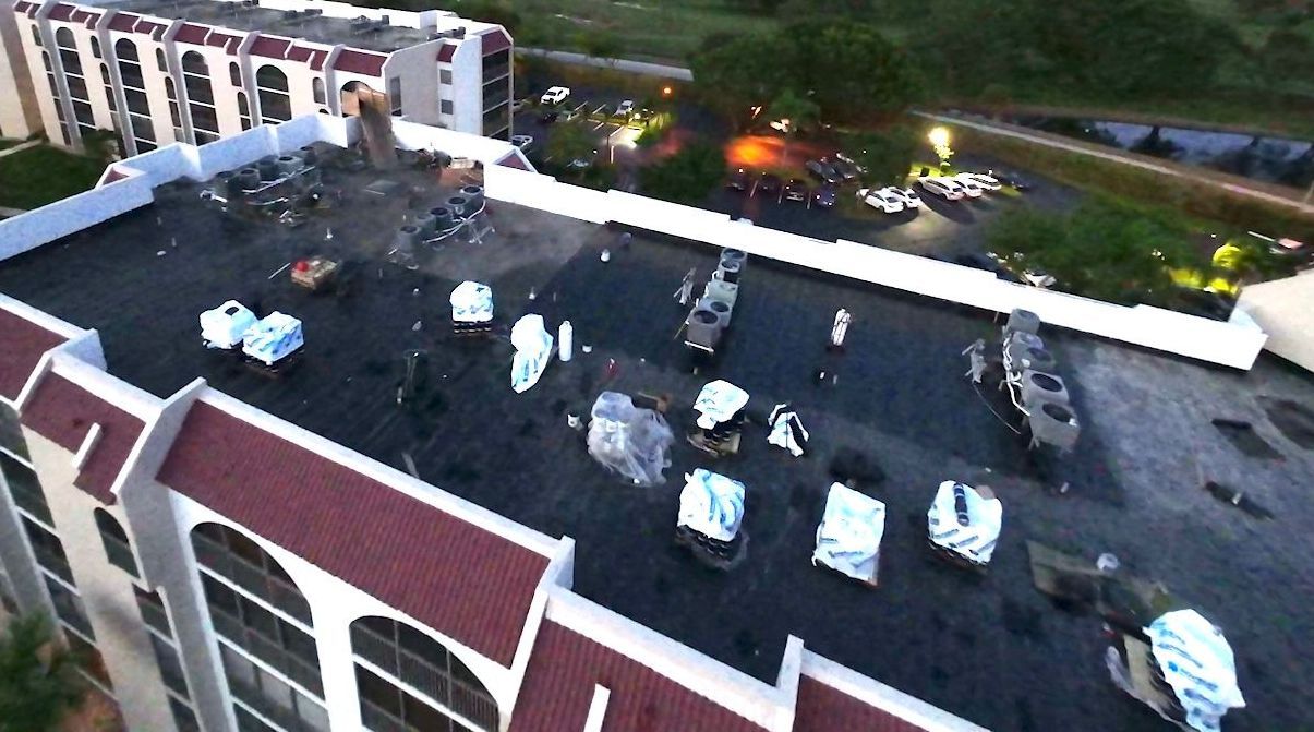 An aerial view of a building with a red roof