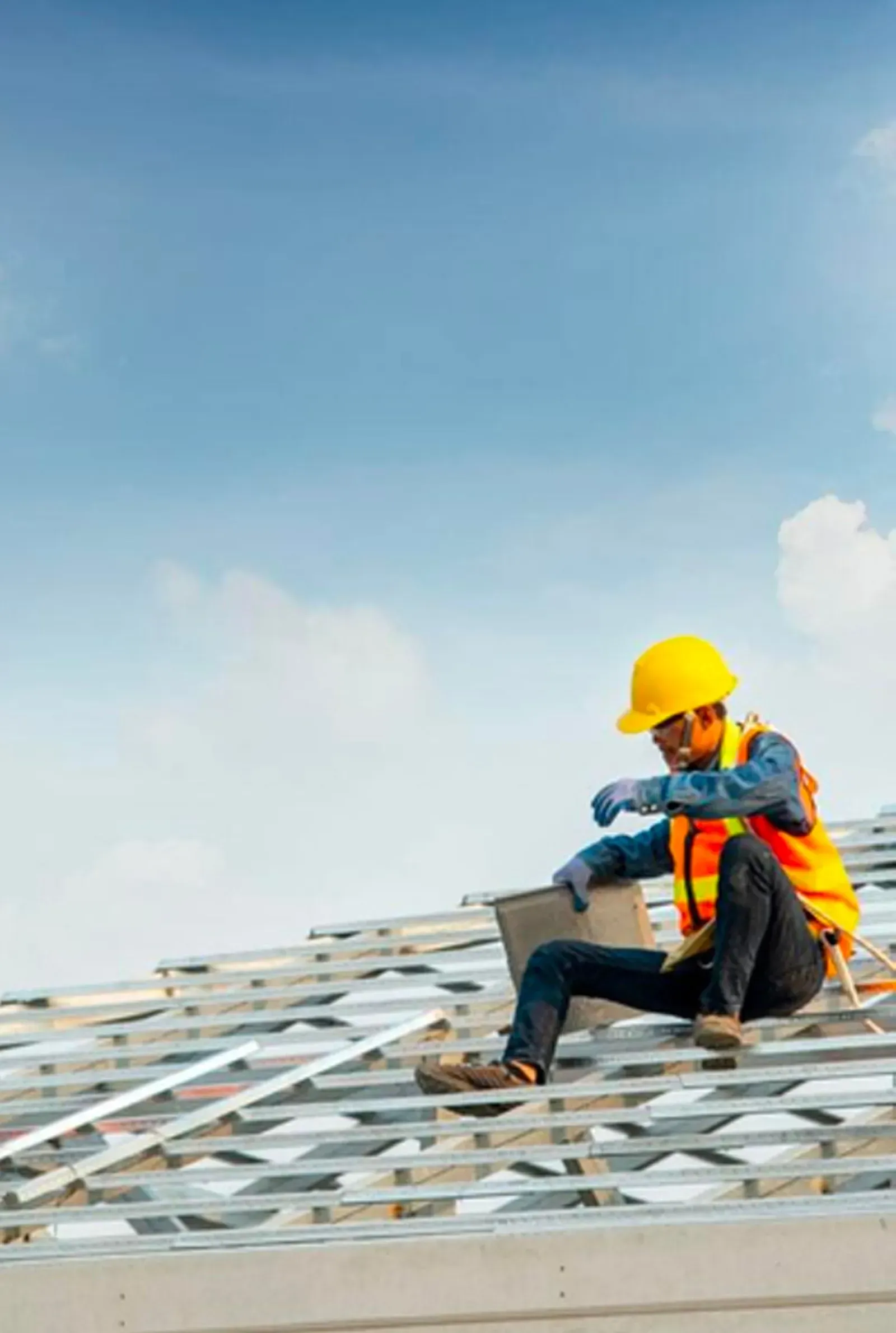 A group of people are working on the roof of a building.