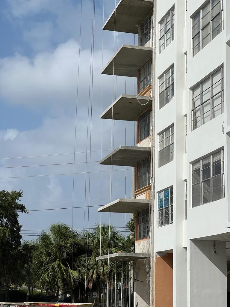 A tall building with a lot of windows and balconies