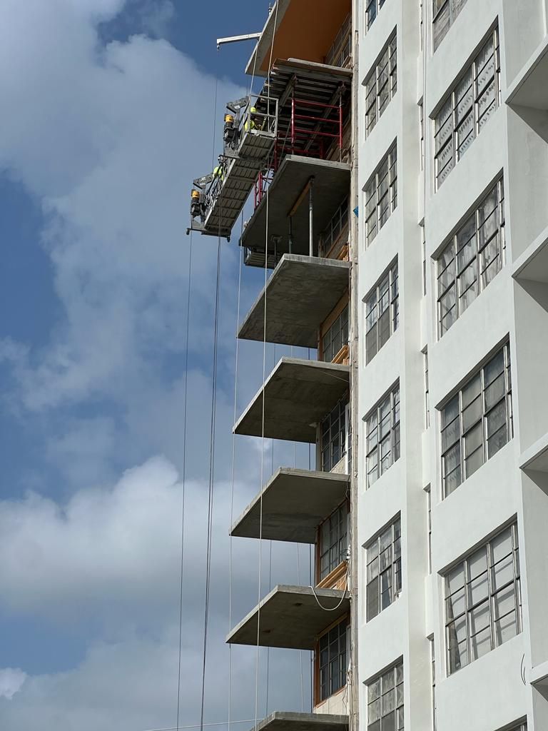 A tall building with a lot of windows under construction