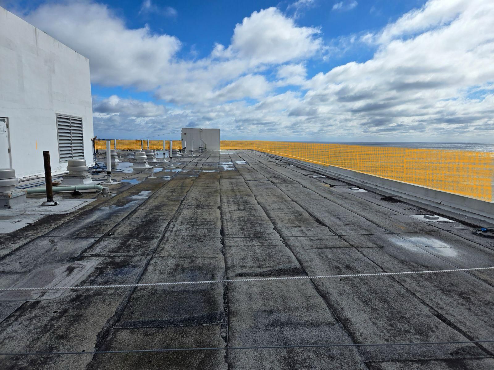 The roof of a building with a view of the ocean.