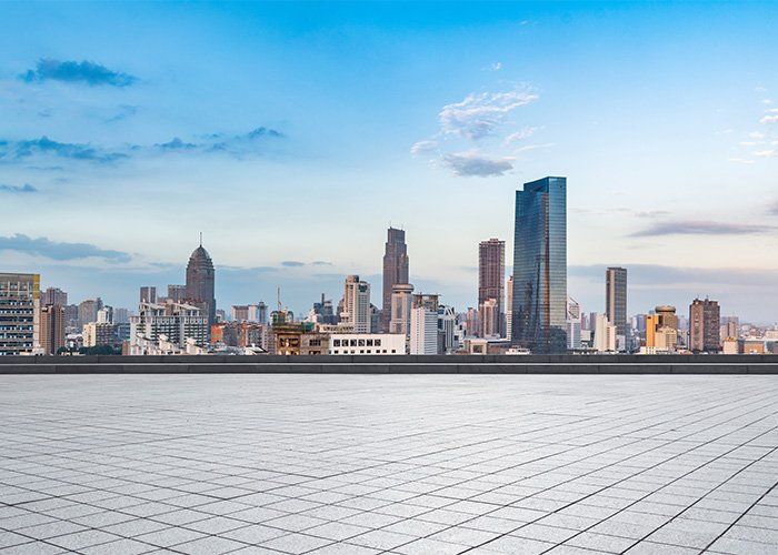 An empty rooftop with a city skyline in the background.