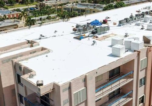 An aerial view of a building with a white roof.
