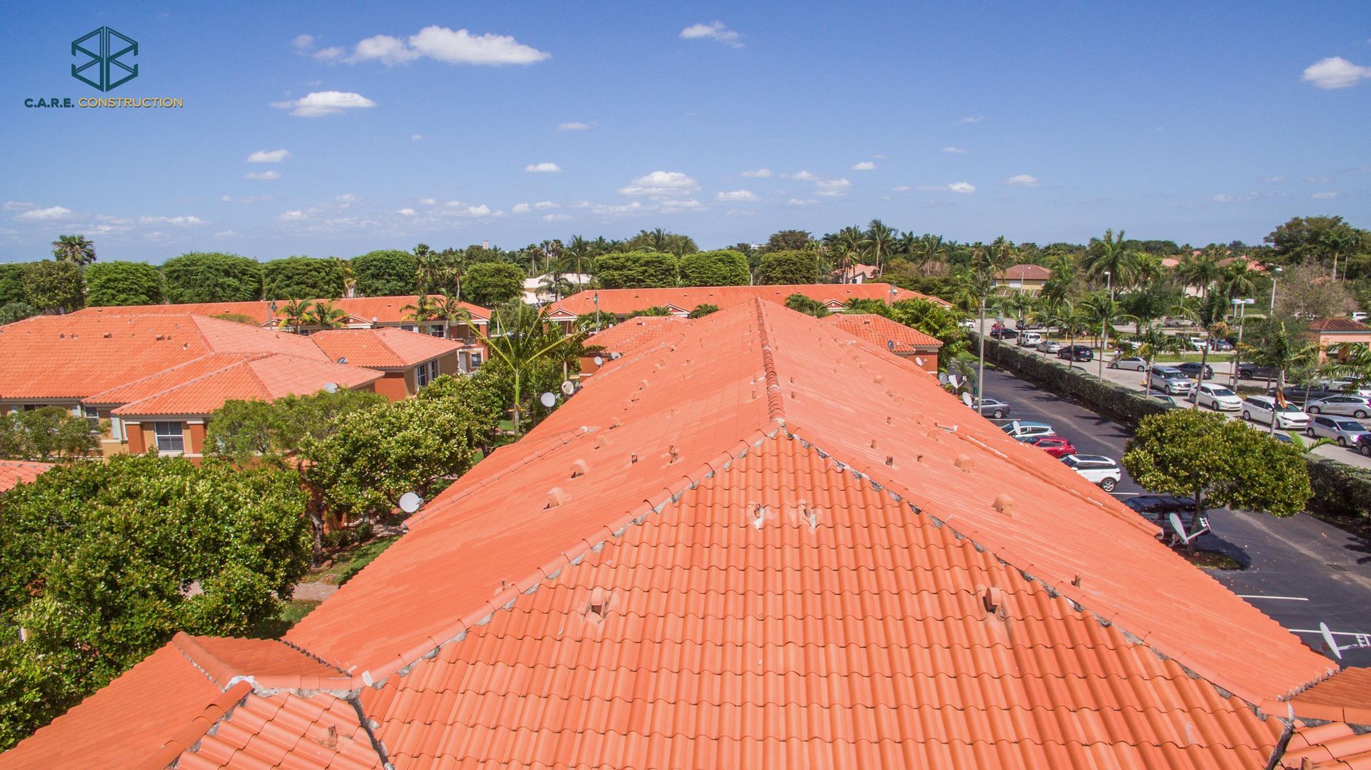 An aerial view of a residential area with a red tiled roof