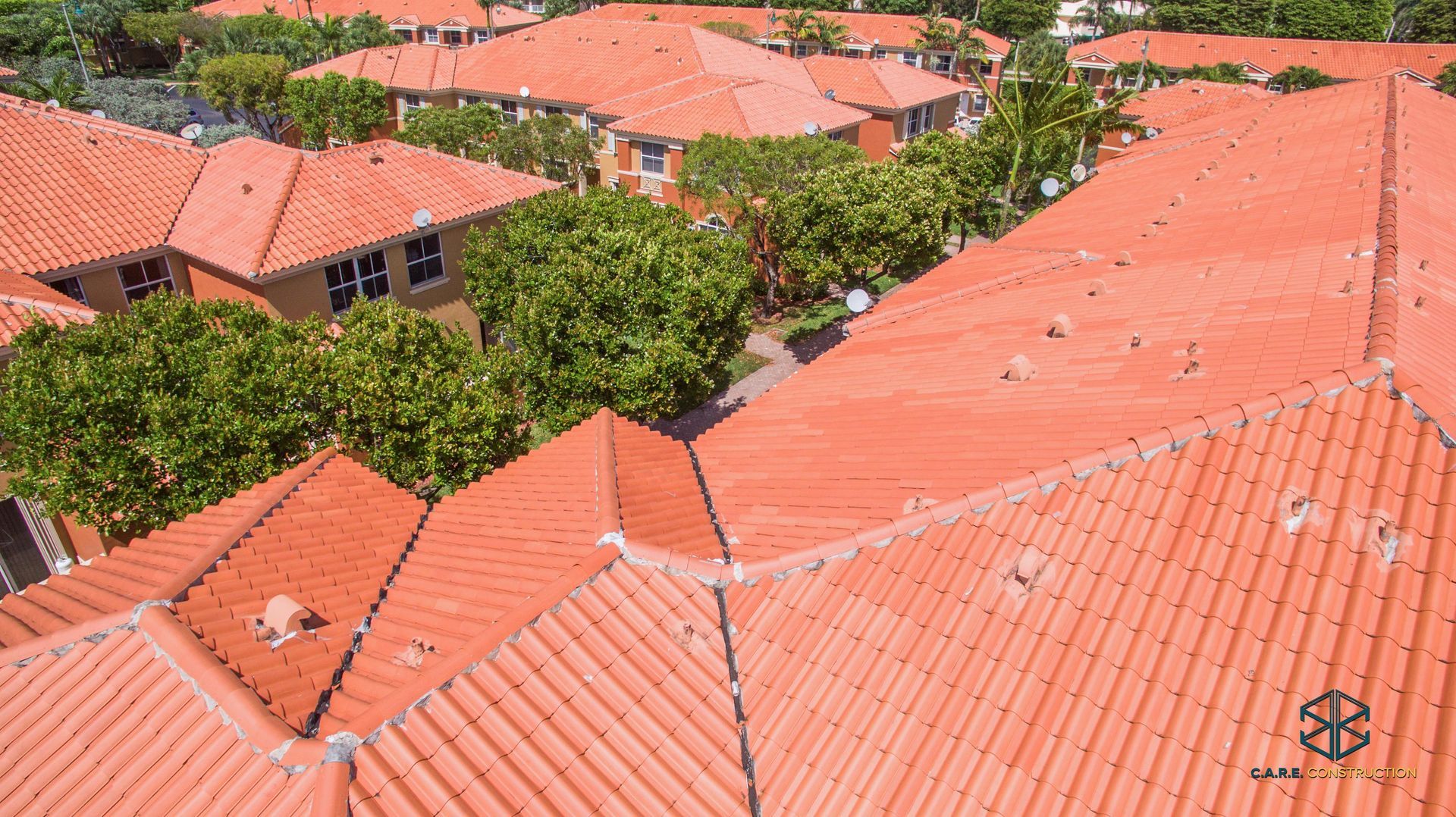 An aerial view of a residential area with red tile roofs
