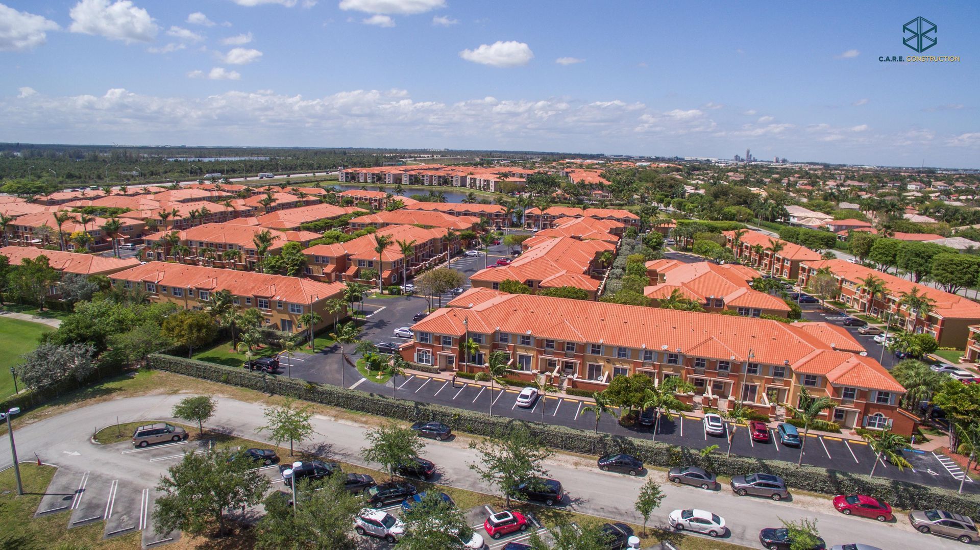 An aerial view of a residential area with red tile roofs