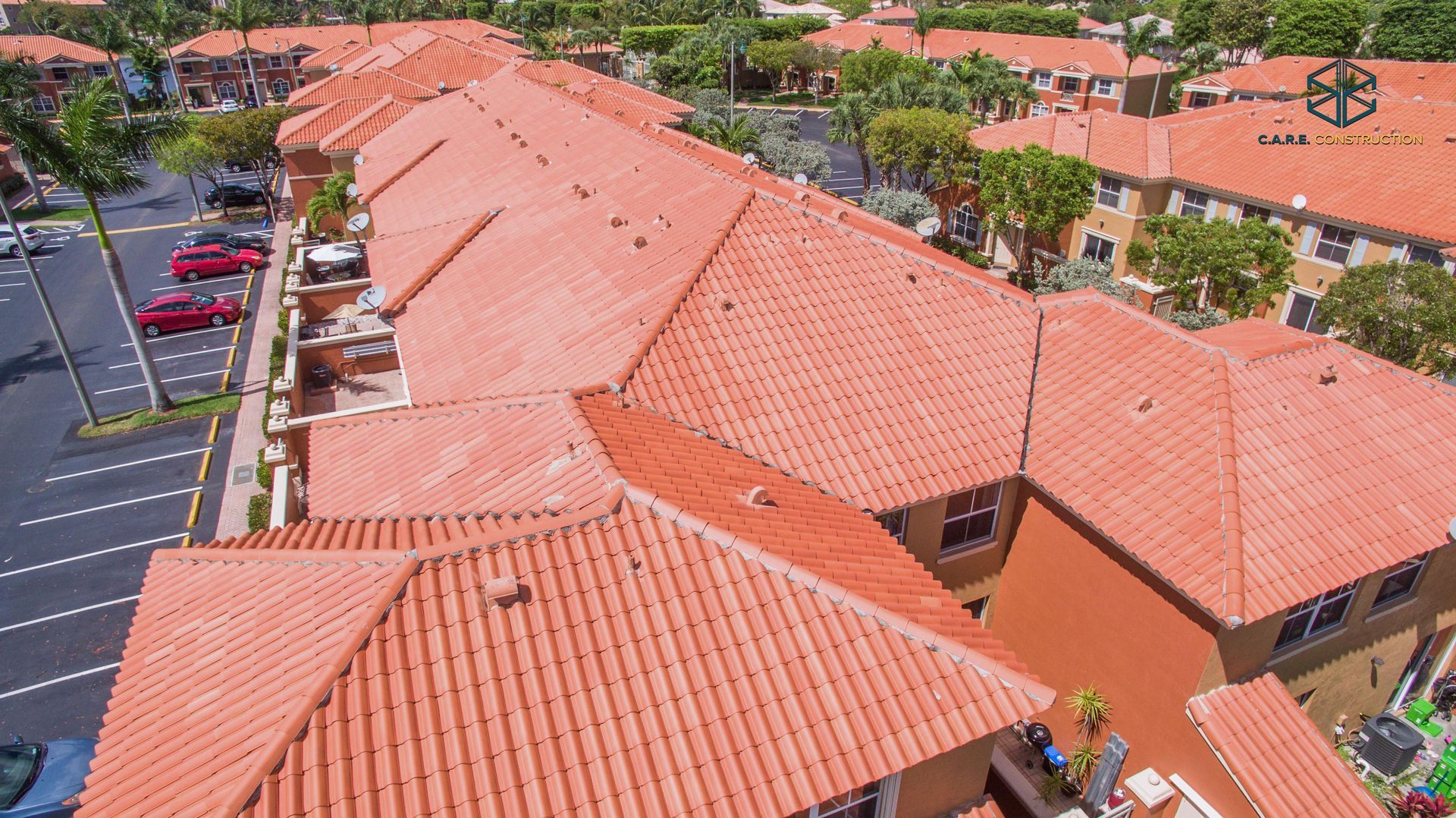 An aerial view of a residential area with red tile roofs