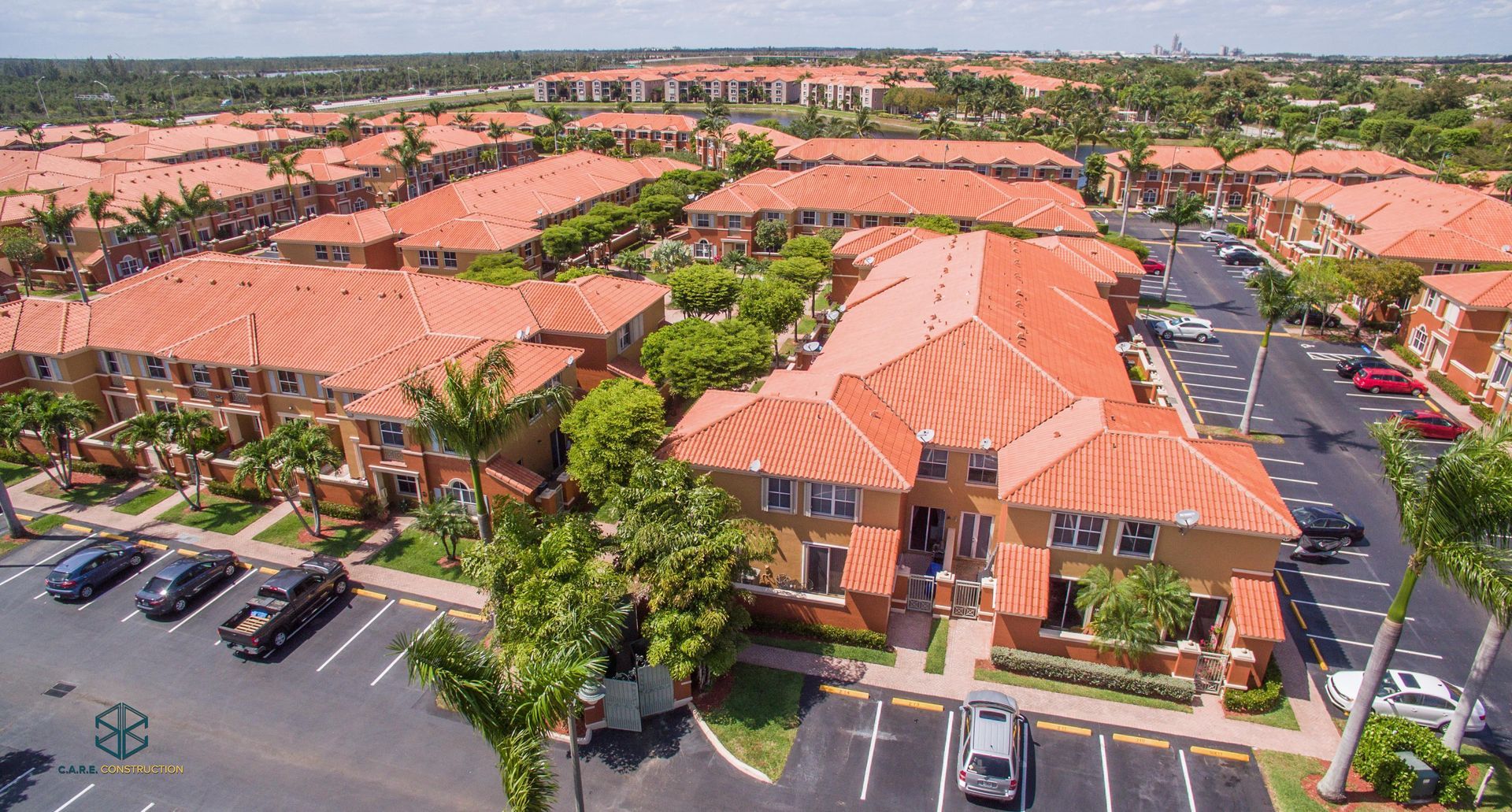 An aerial view of a residential area with red tile roofs