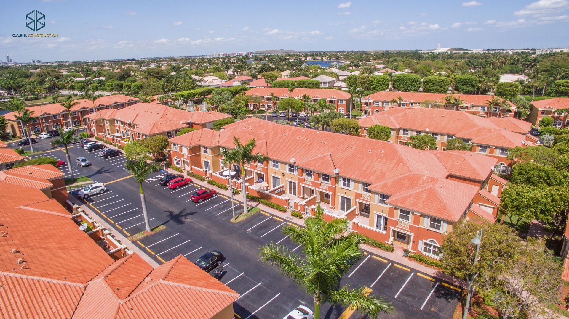 An aerial view of a residential area with red tile roofs