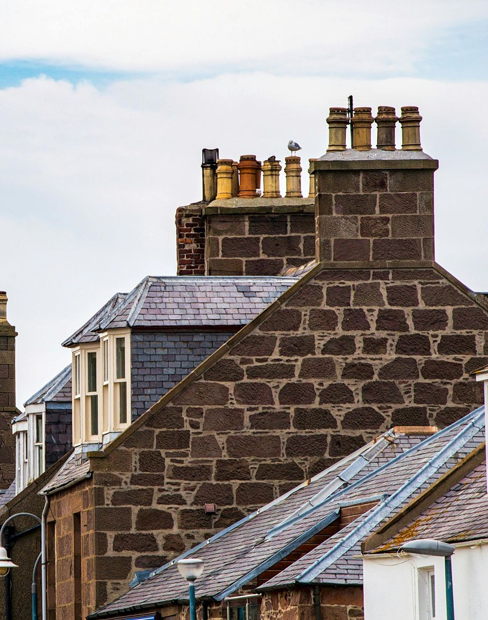 A group of people are working on the roof of a building.