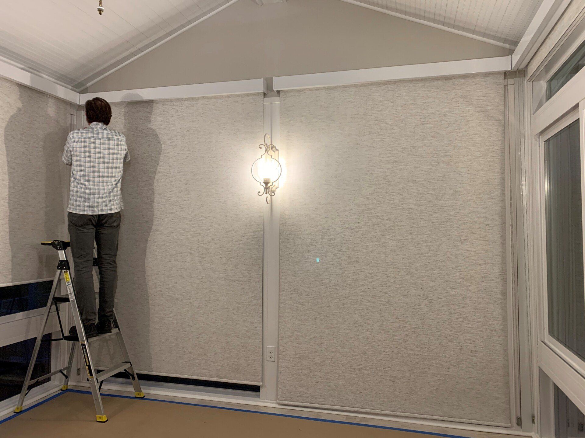 Man standing in ladder — Erie, PA — Mcqueen Inc.