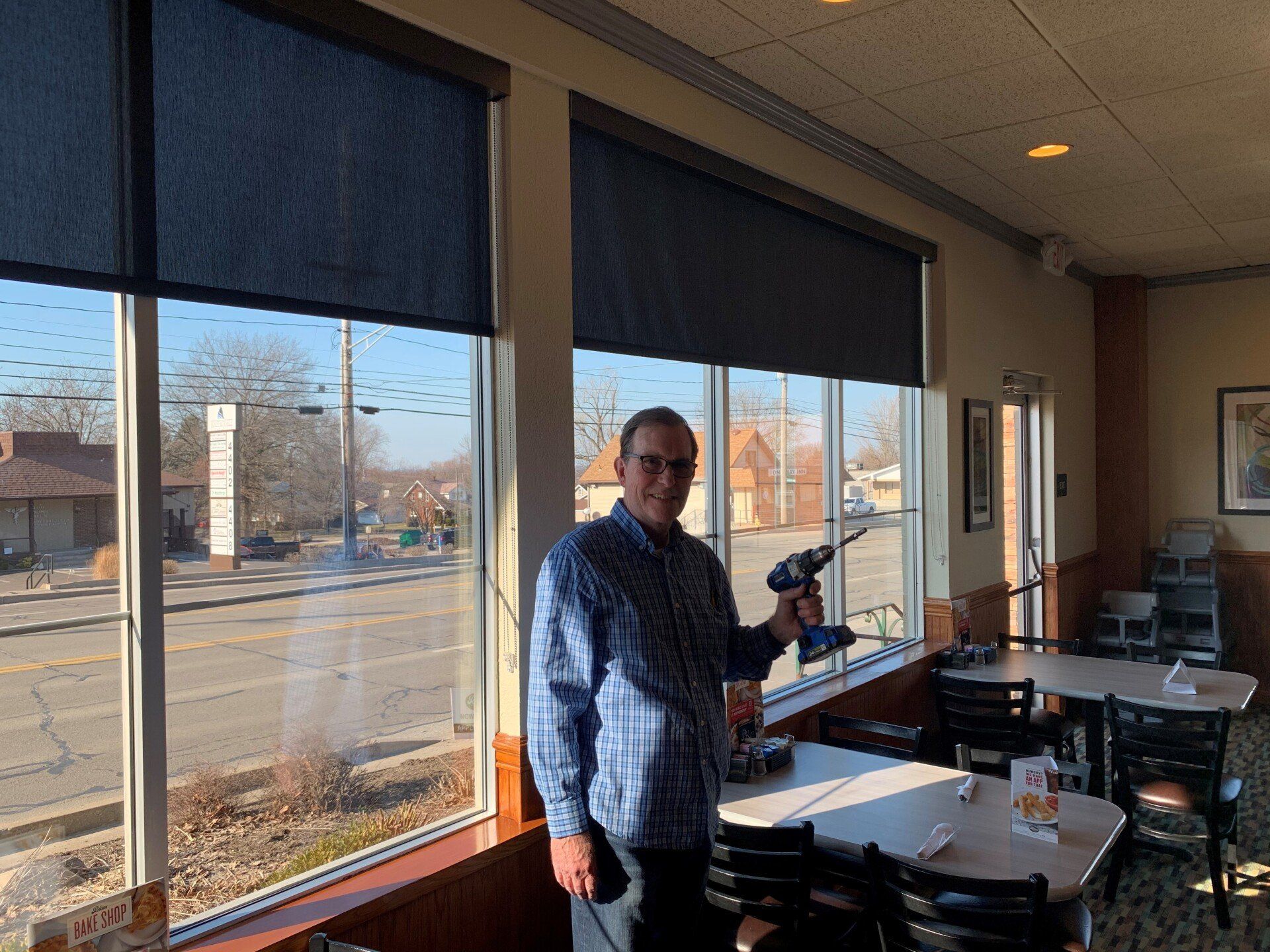 Man holding a drill — Erie, PA — Mcqueen Inc.