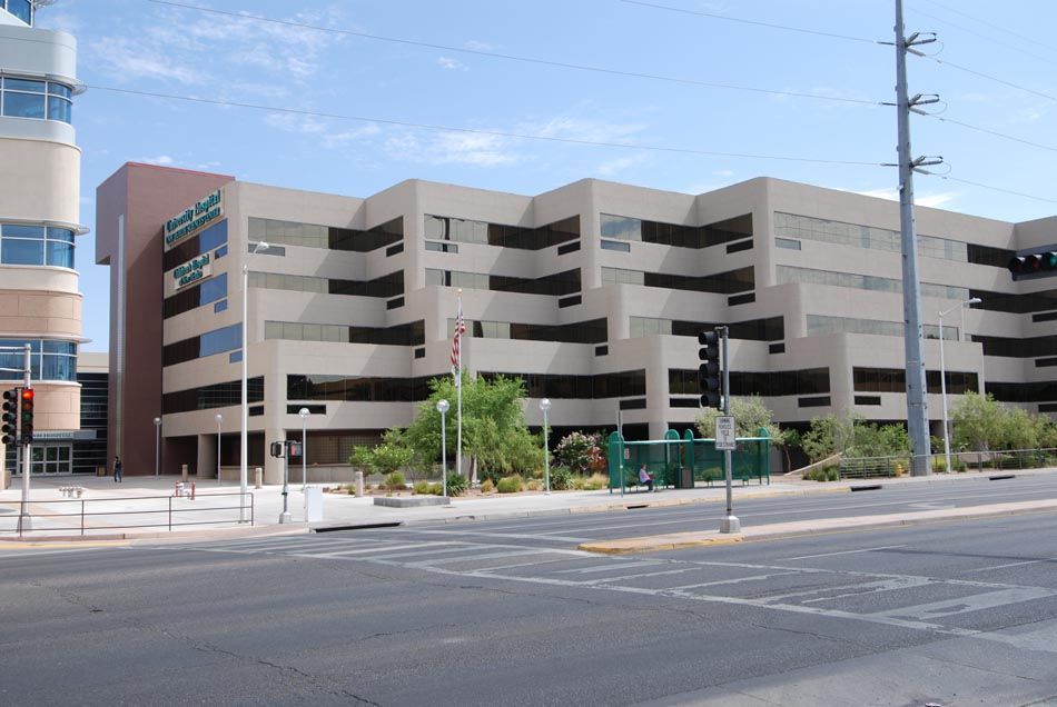 A large building with a parking garage in front of it