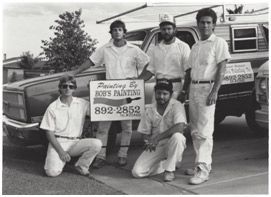 A black and white photo of a group of men holding a sign that says bob 's painting