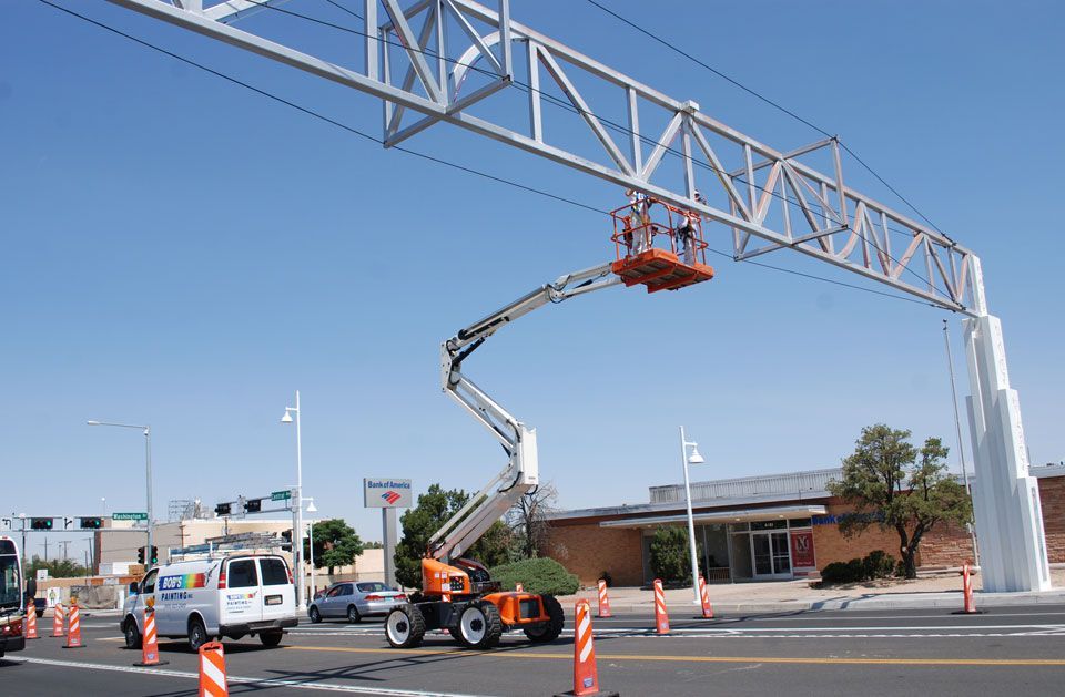 A crane is being used to build a bridge over a street