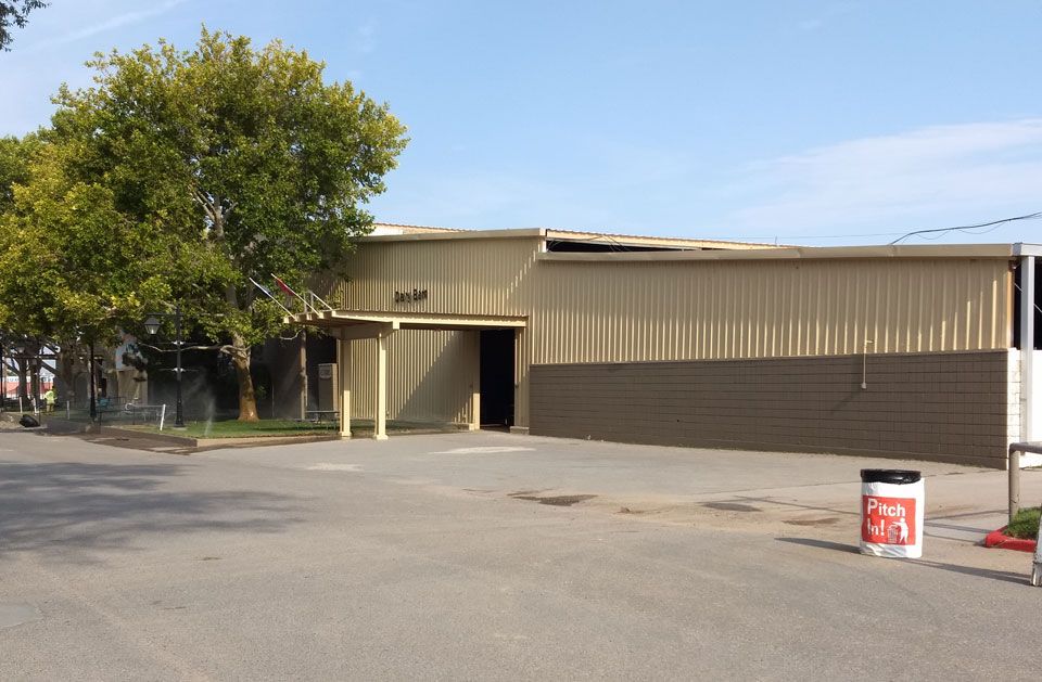 A large building with a coca cola can in front of it