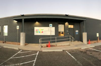 A large building with a sign that says new world offices