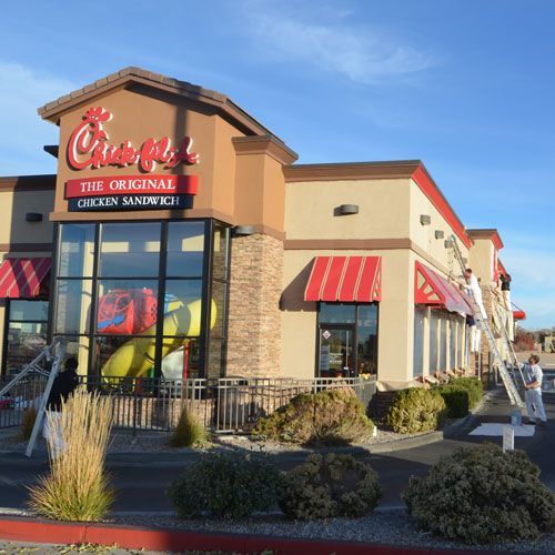 A chick fil a restaurant with a red awning