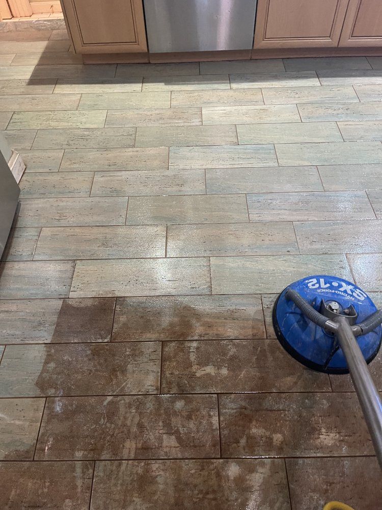 A tiled floor with a yellow brush on it