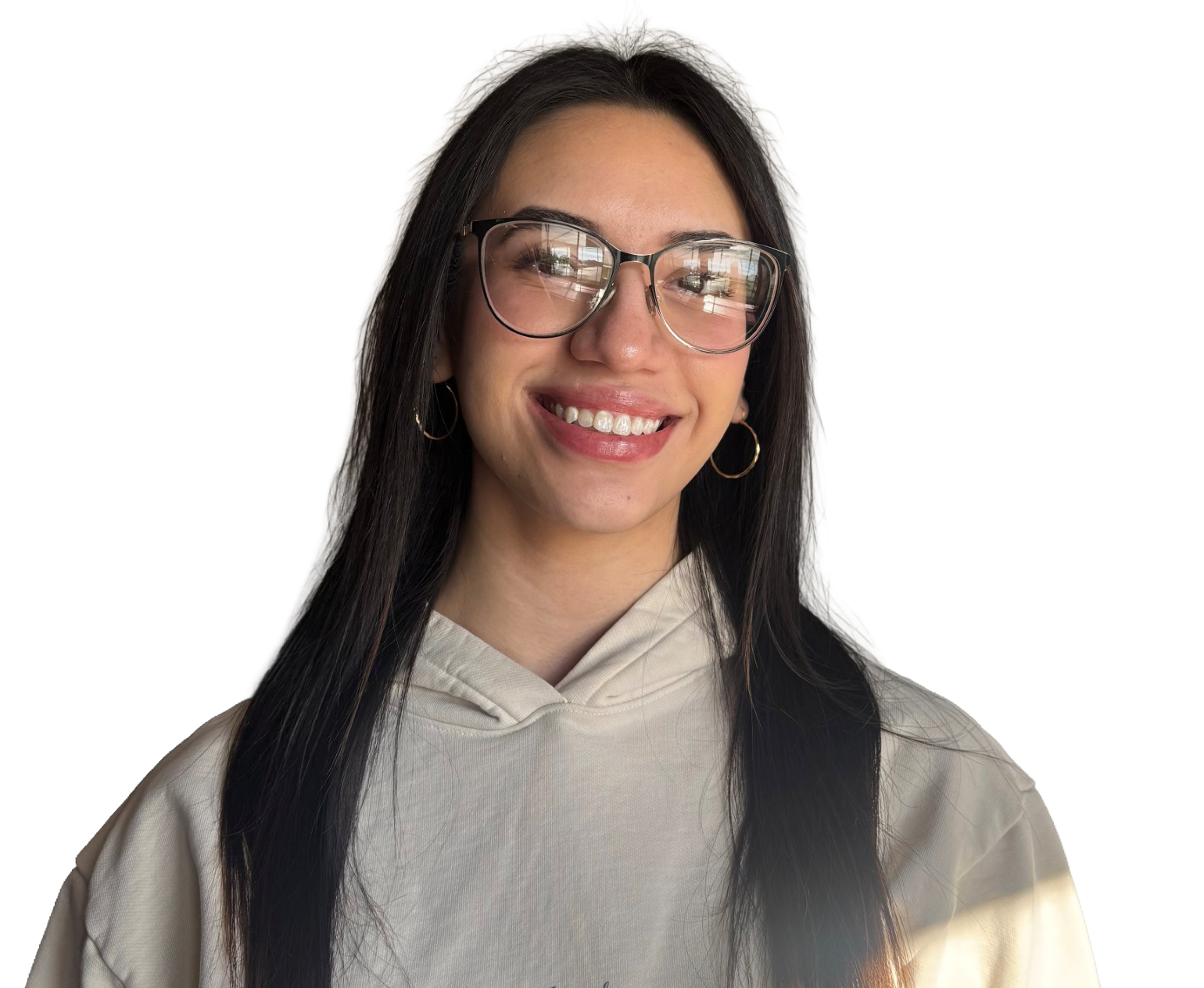 A woman wearing a plaid shirt and a brown tank top is smiling.