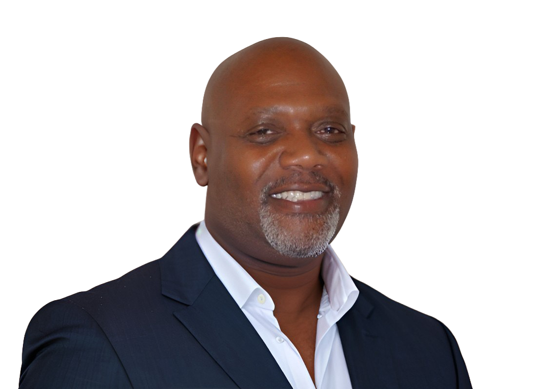 A woman wearing a black jacket and a necklace smiles for the camera