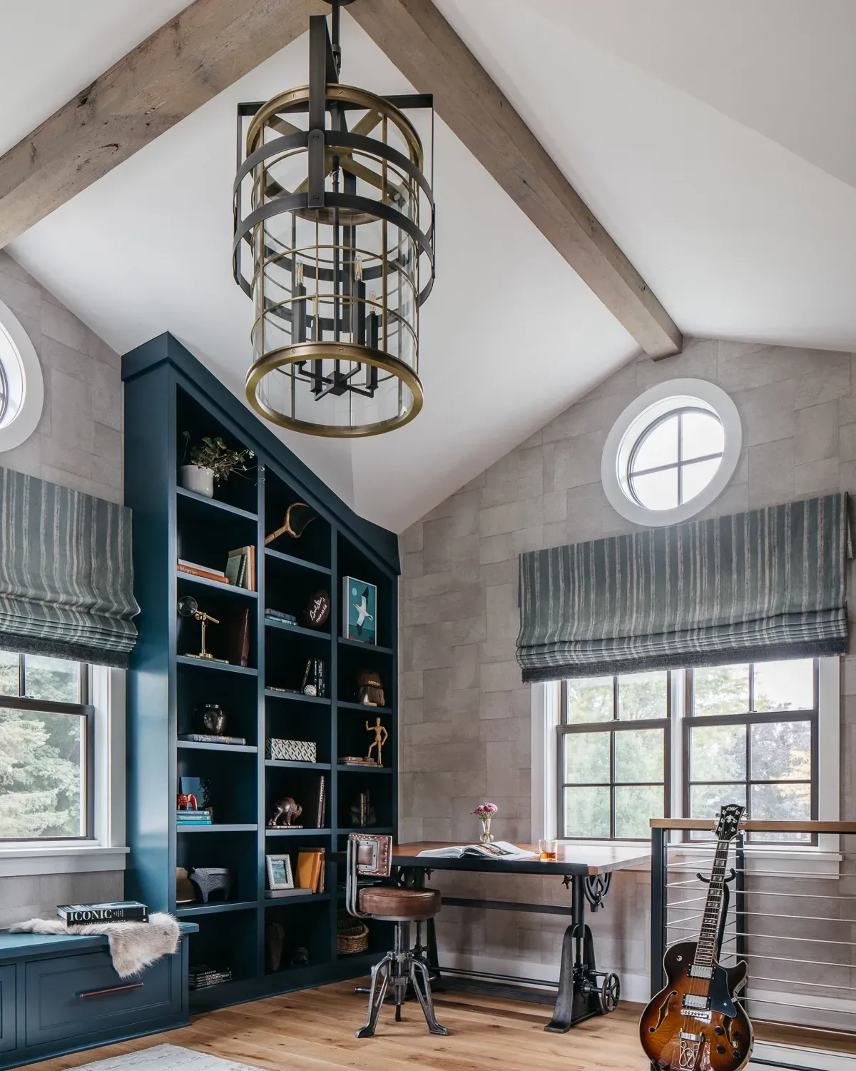 A room with a desk and a guitar in it