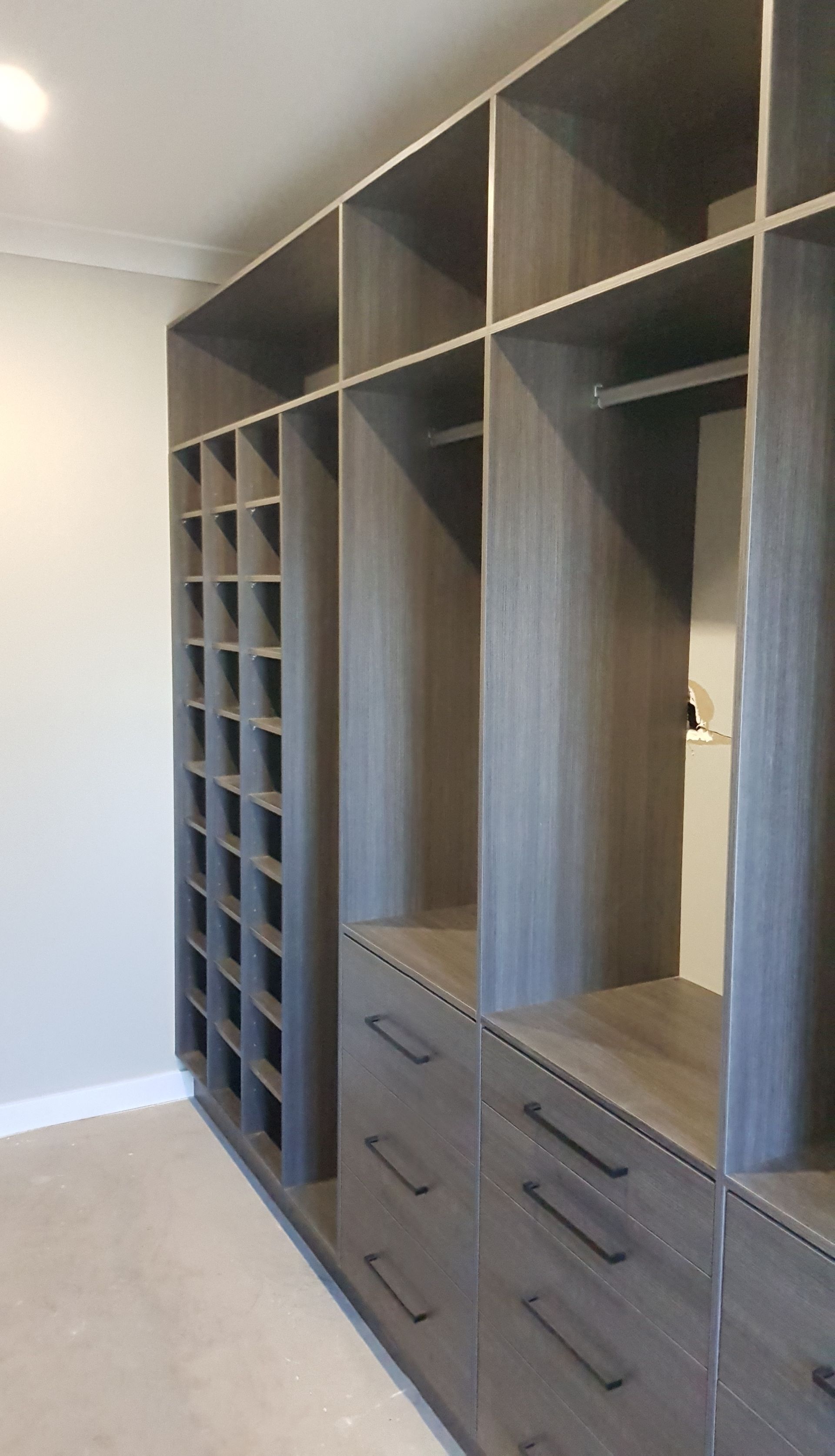 Built-in grey wood closet with drawers, shelves, and cubbies — Protech Renovations & Joinery in Gregory Hills, NSW