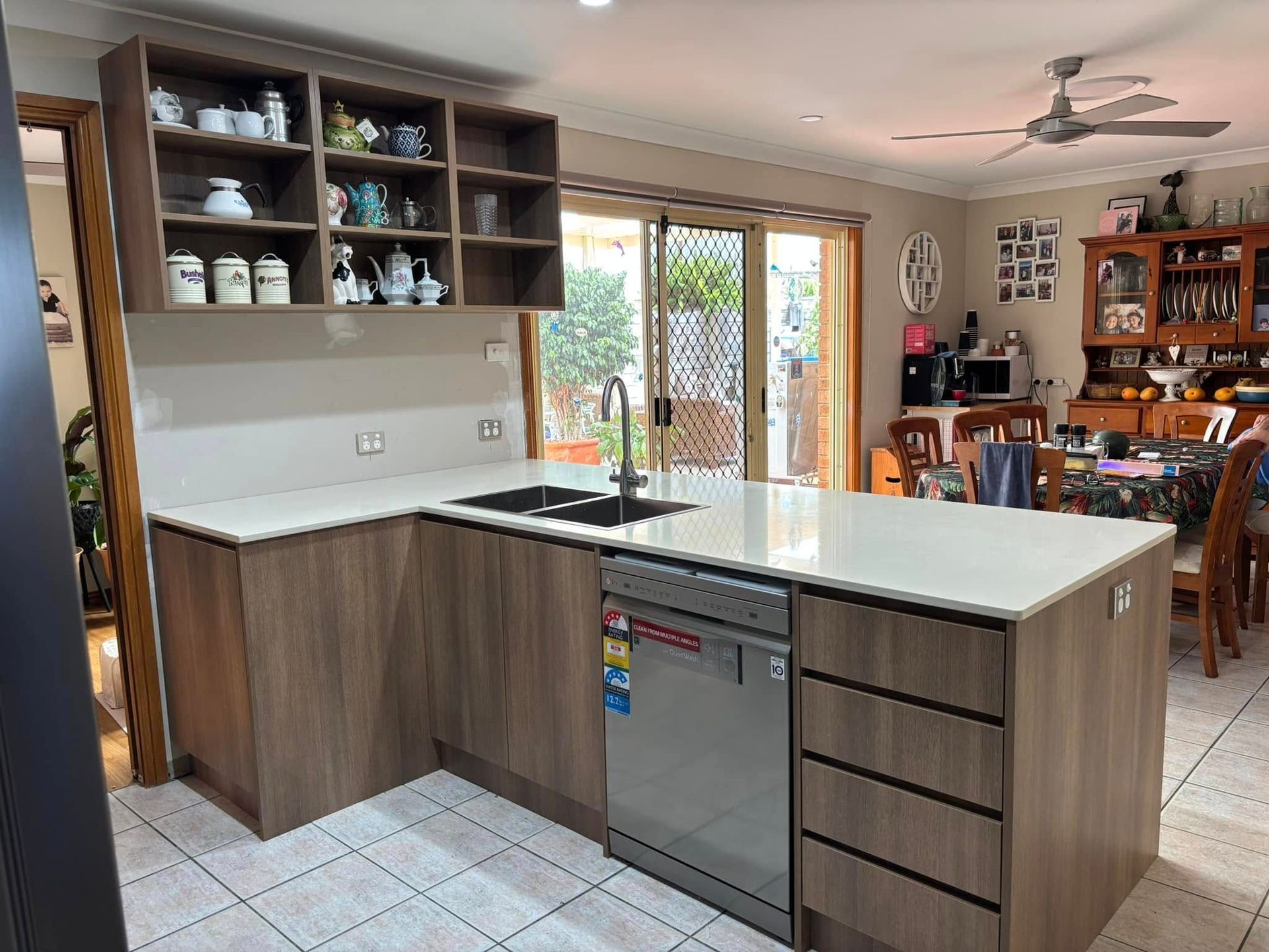 Modern Kitchen With Wood Cabinets, White Countertops, And Stainless Steel Dishwasher — Protech Renovations & Joinery in Gregory Hills, NSW