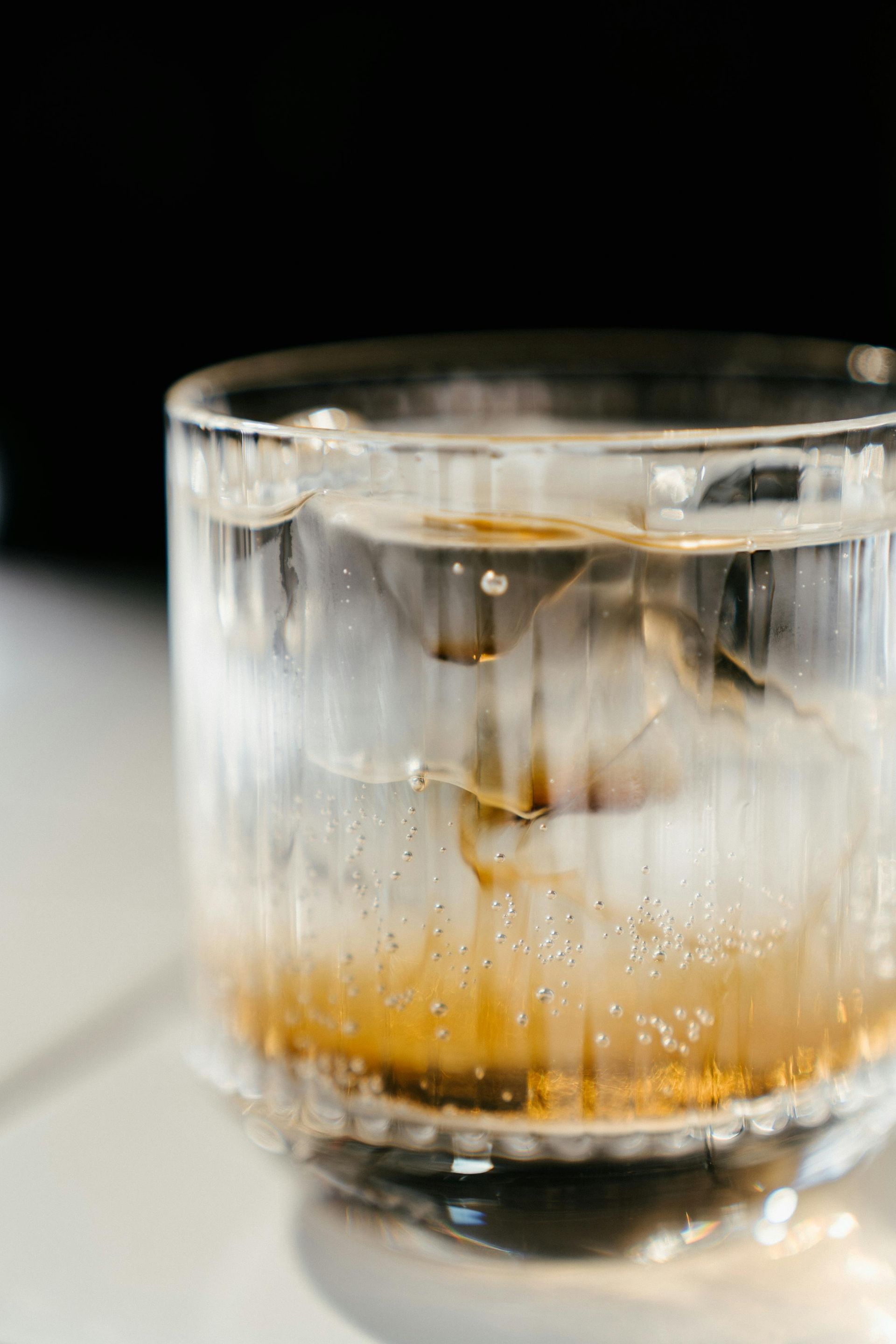Glass of whiskey with ice cubes from a home ice machine, showing clear ice quality for entertaining