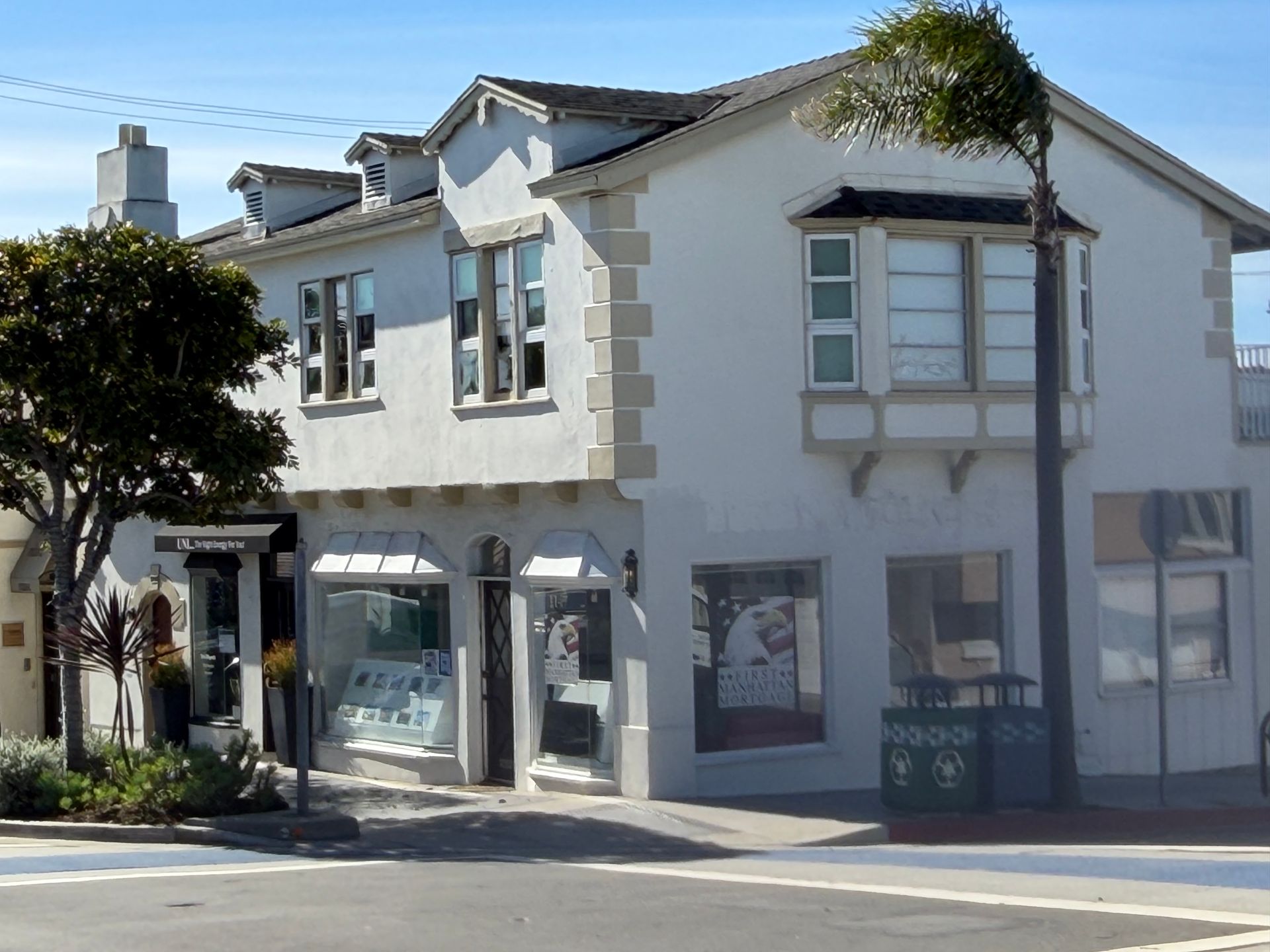 Aerial view of coastal homes and beach with turquoise water.