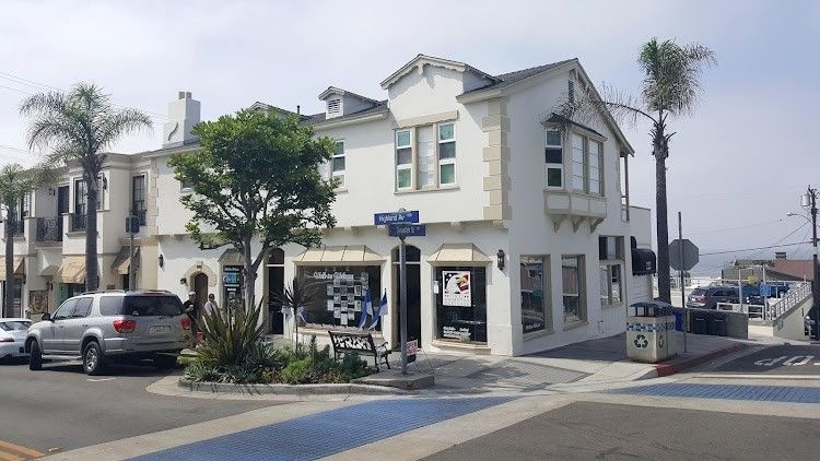 Aerial view of coastal homes and beach with turquoise water.
