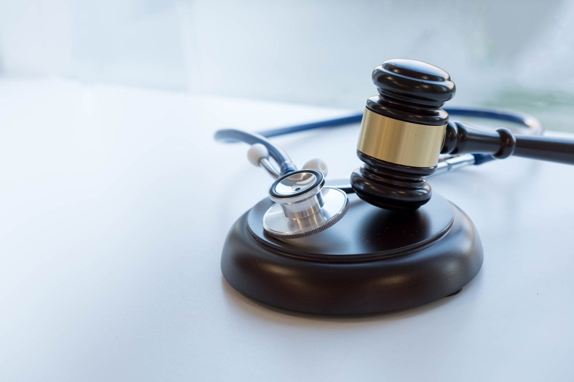 A judge 's gavel and stethoscope are on a table.