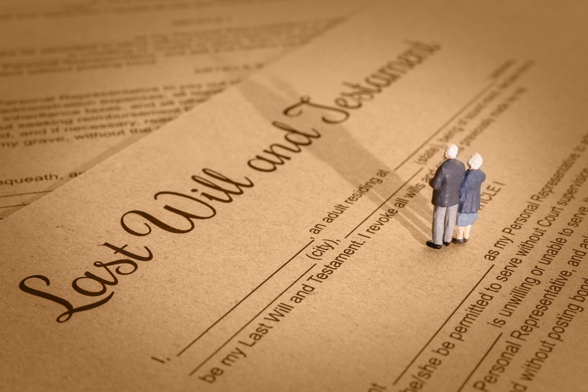 Two figurines standing on top of a last will and testament