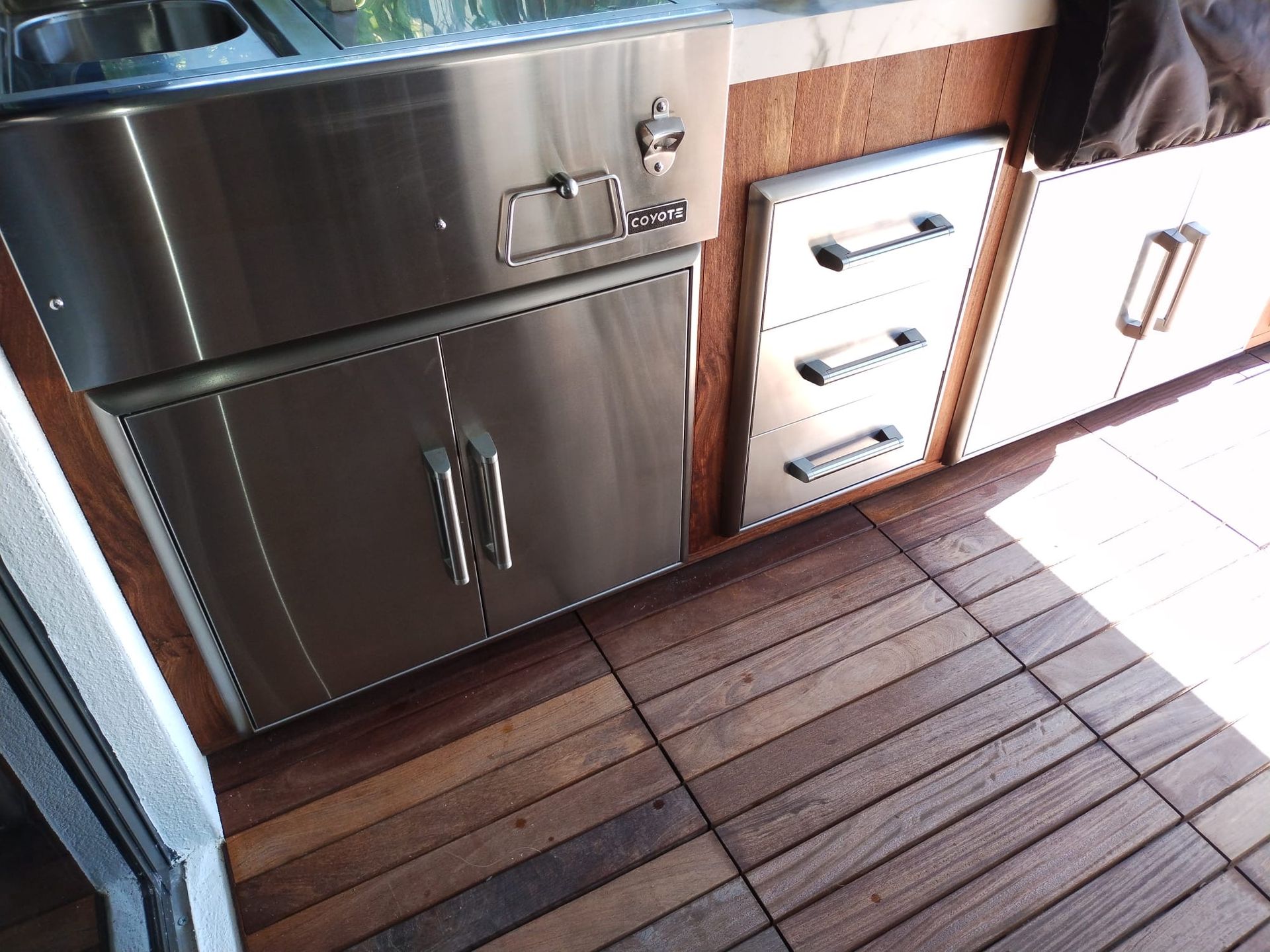 A kitchen with stainless steel cabinets and drawers