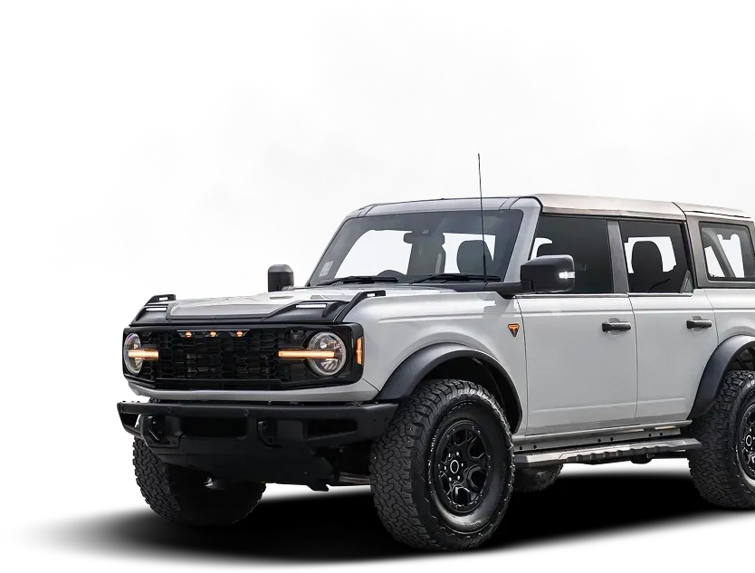 White Ford Bronco SUV parked, black accents, off-road tires. | Fedel's Auto Care