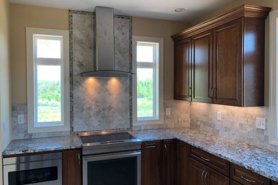 A kitchen with stainless steel appliances and granite counter tops.