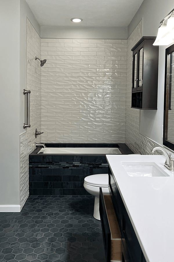 A bathroom with a sink , toilet , bathtub and shower.