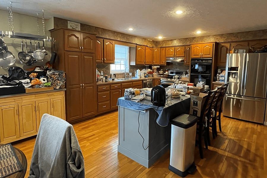 A kitchen with stainless steel appliances and wooden cabinets.