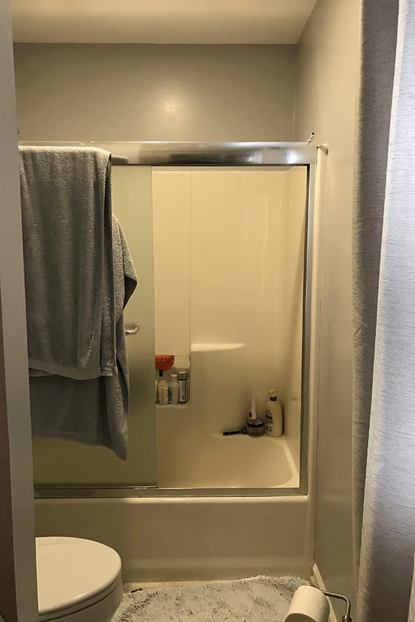 A bathroom with a toilet , shower , and bathtub.