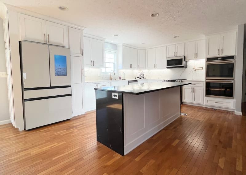 There is a large island in the middle of the kitchen.