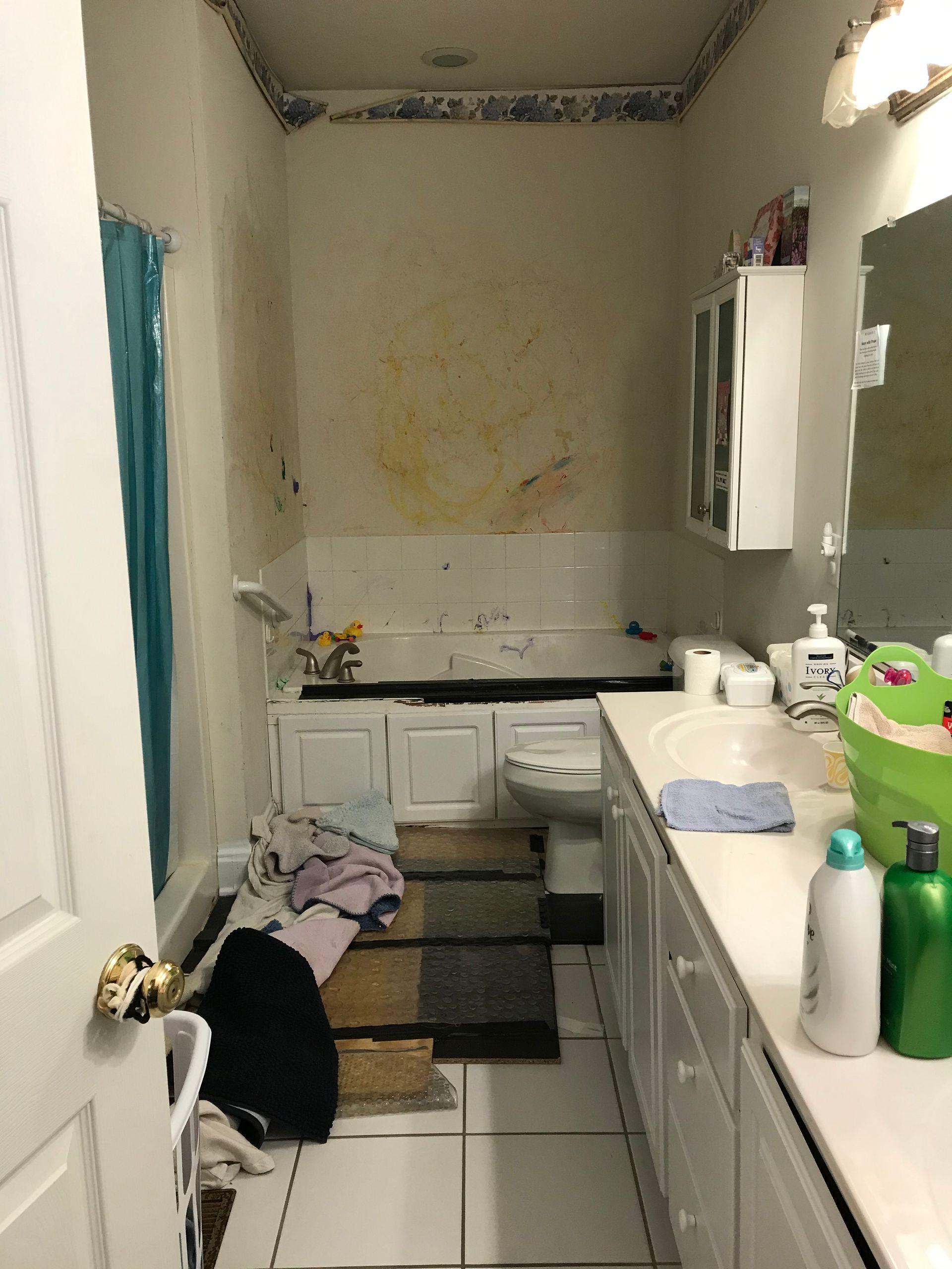 A kitchen with a refrigerator , microwave , sink , and chairs.
