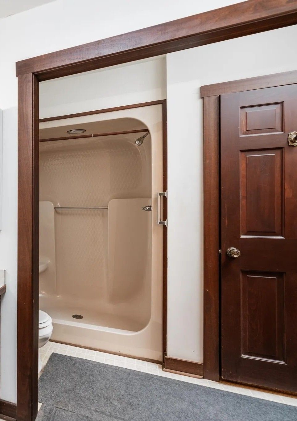 A kitchen with a refrigerator , microwave , sink , and chairs.