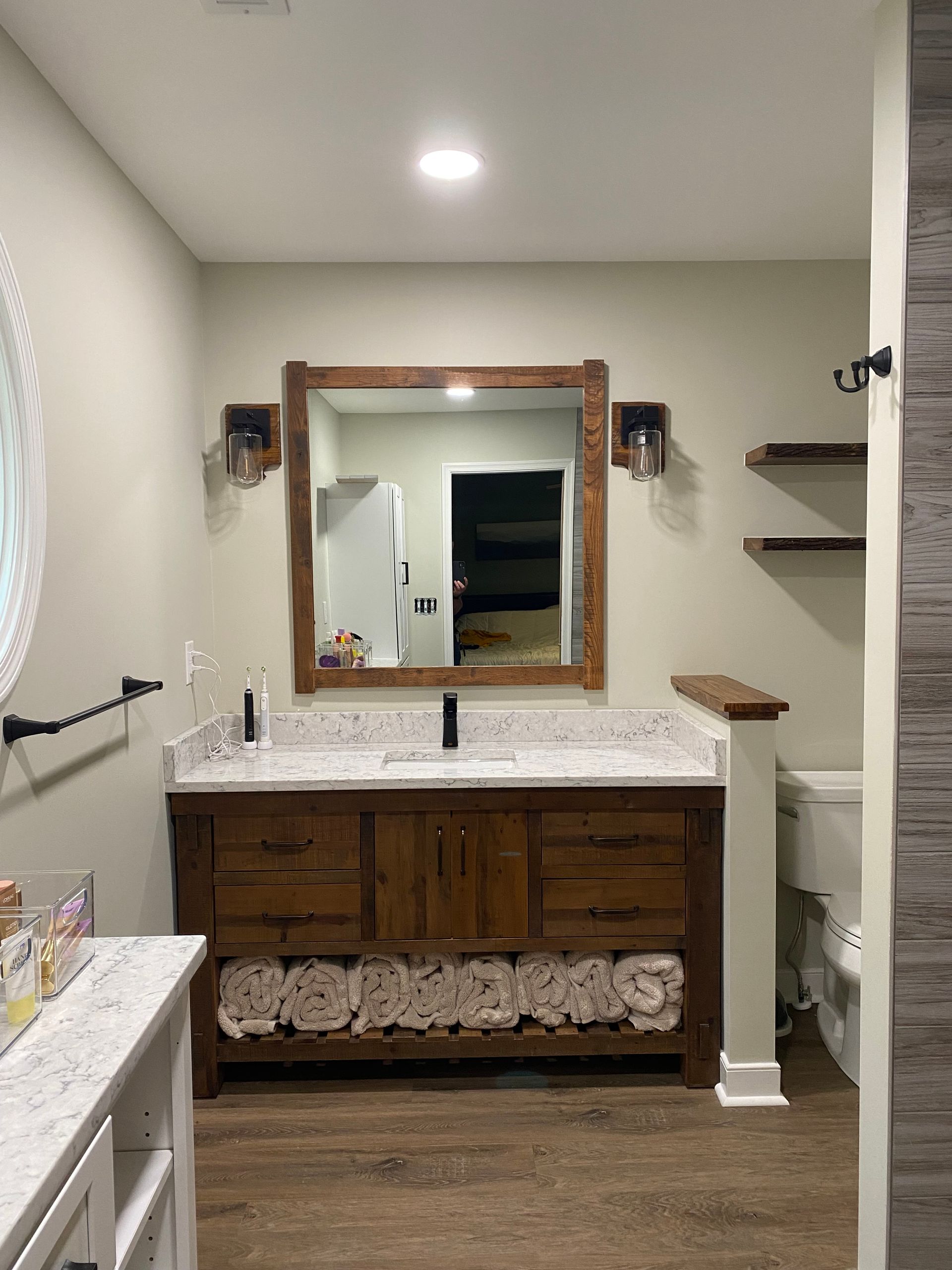 A kitchen with white cabinets , stainless steel appliances , a sink , and a refrigerator.