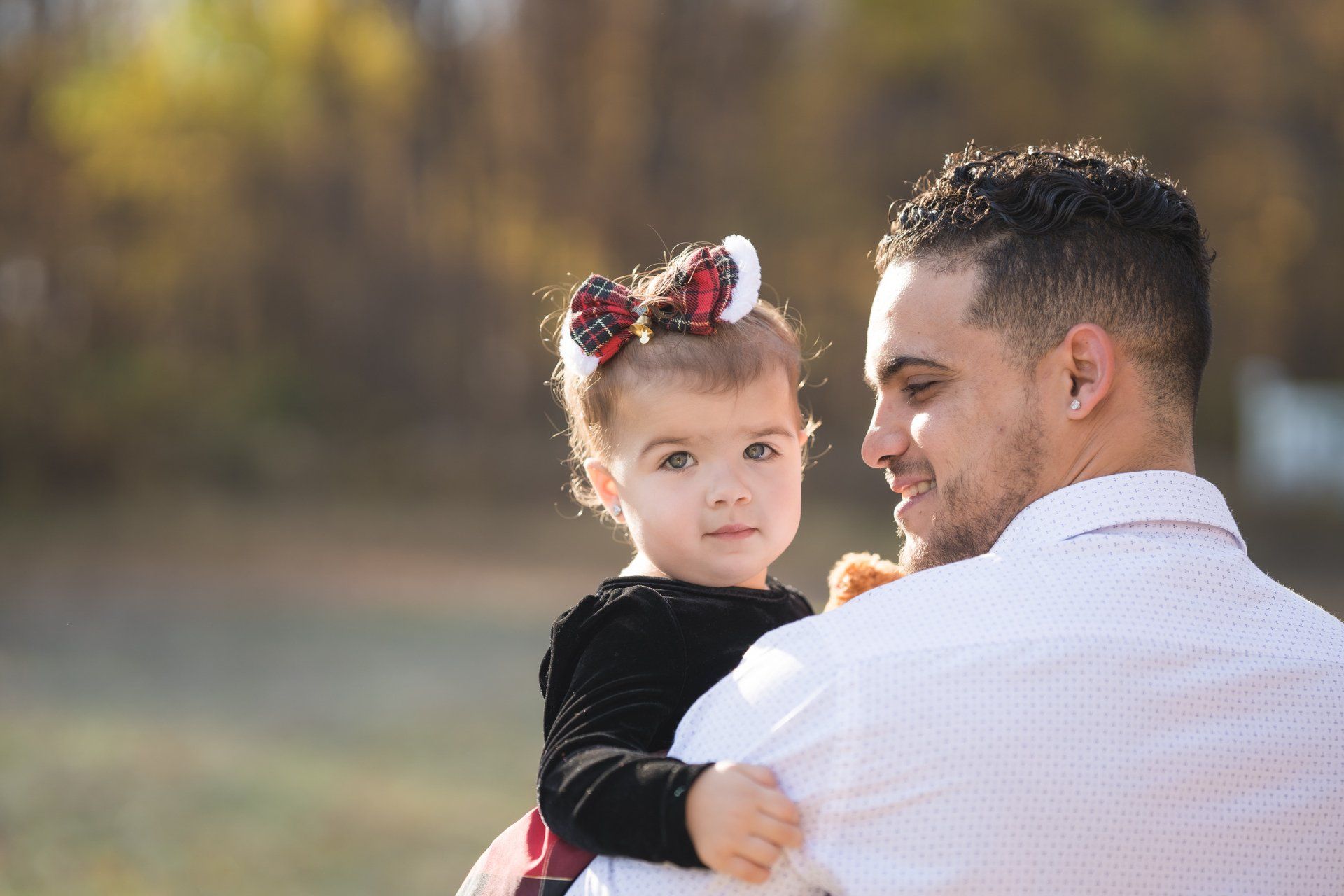 A man is holding a little girl in his arms.