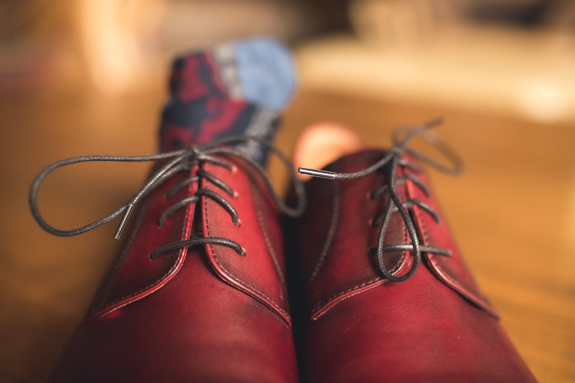 A pair of red shoes on a person 's feet.