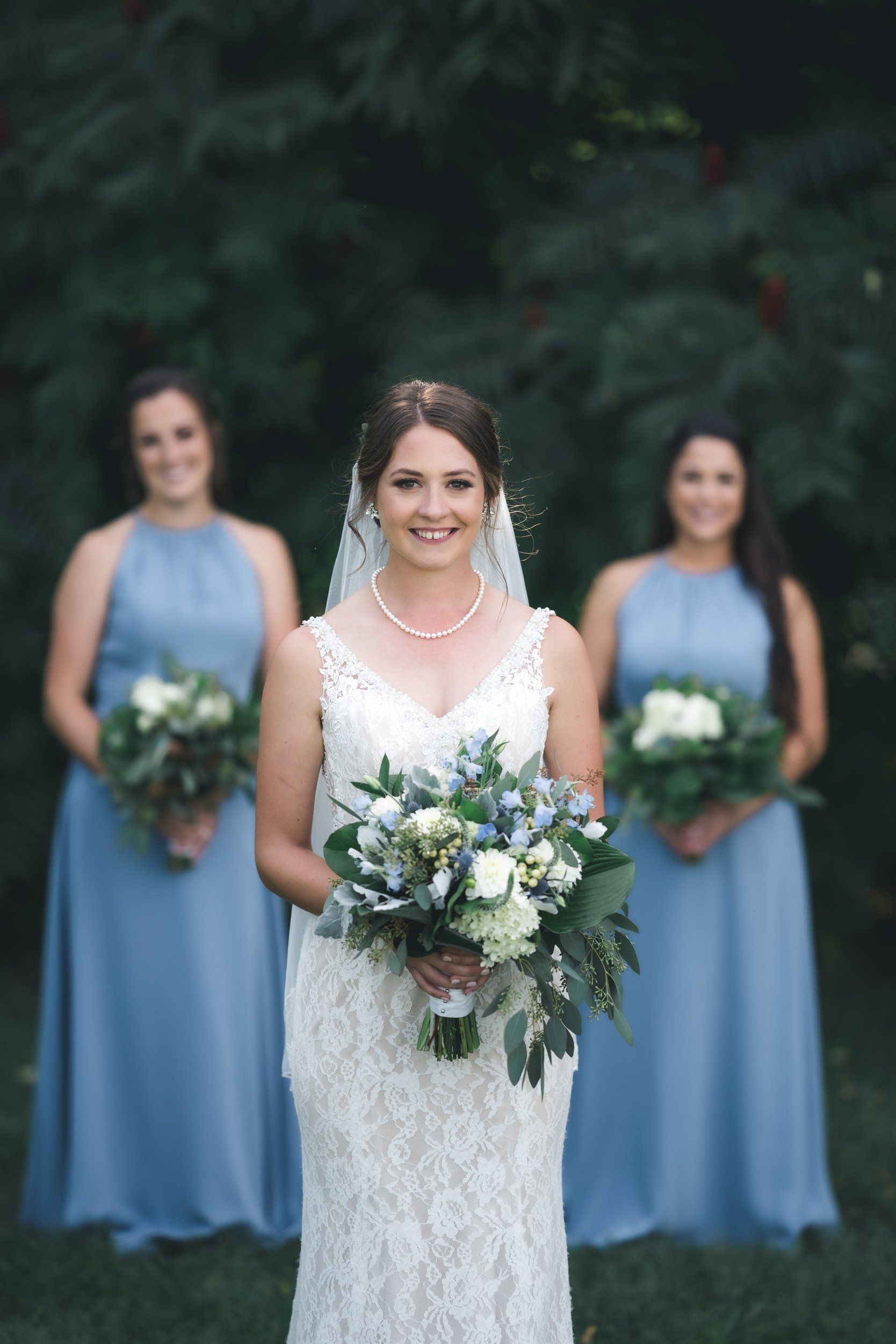 A bride and her bridesmaids are posing for a picture.