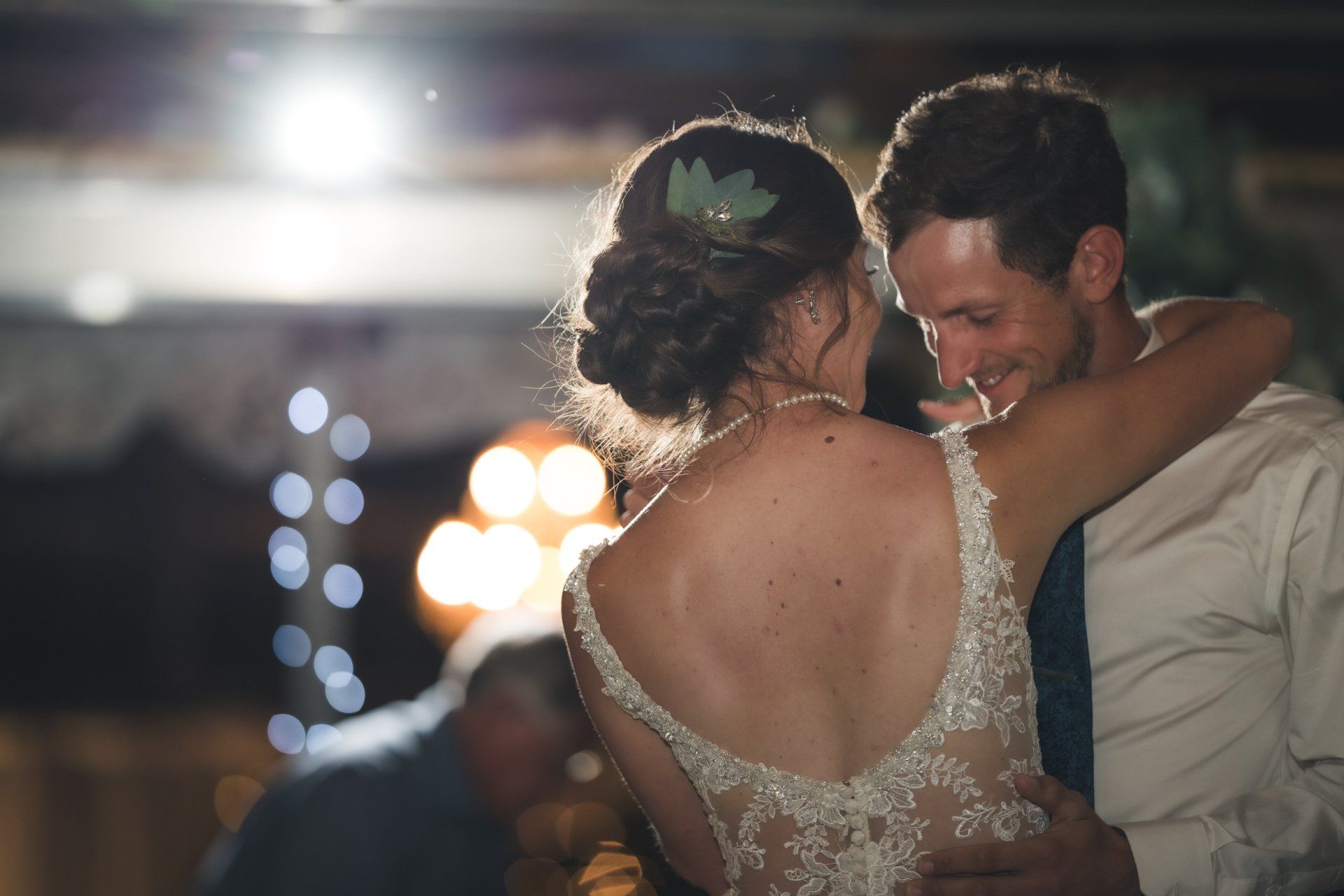 A bride and groom are dancing together at their wedding reception.