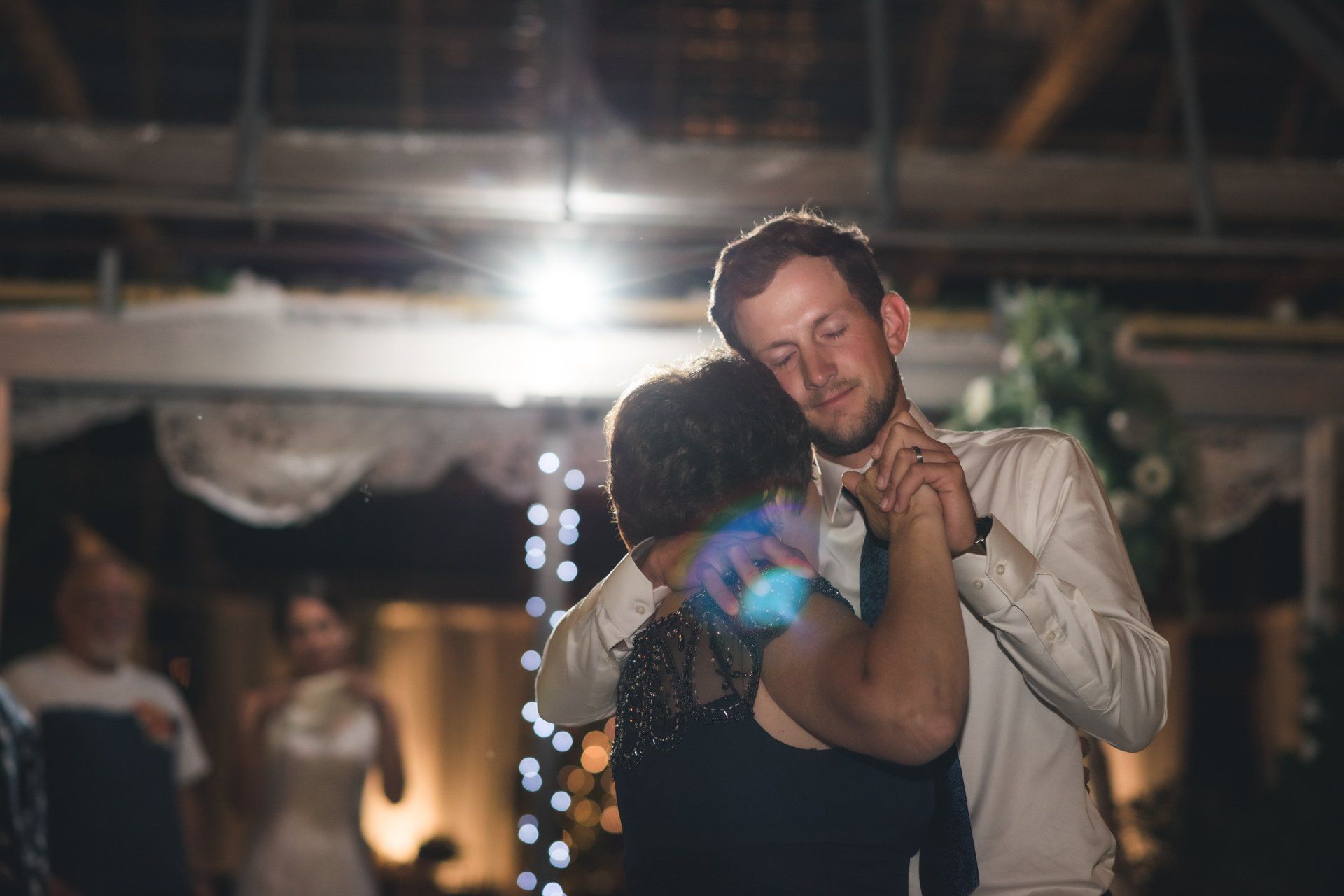 A man and a woman are dancing together at a wedding reception.